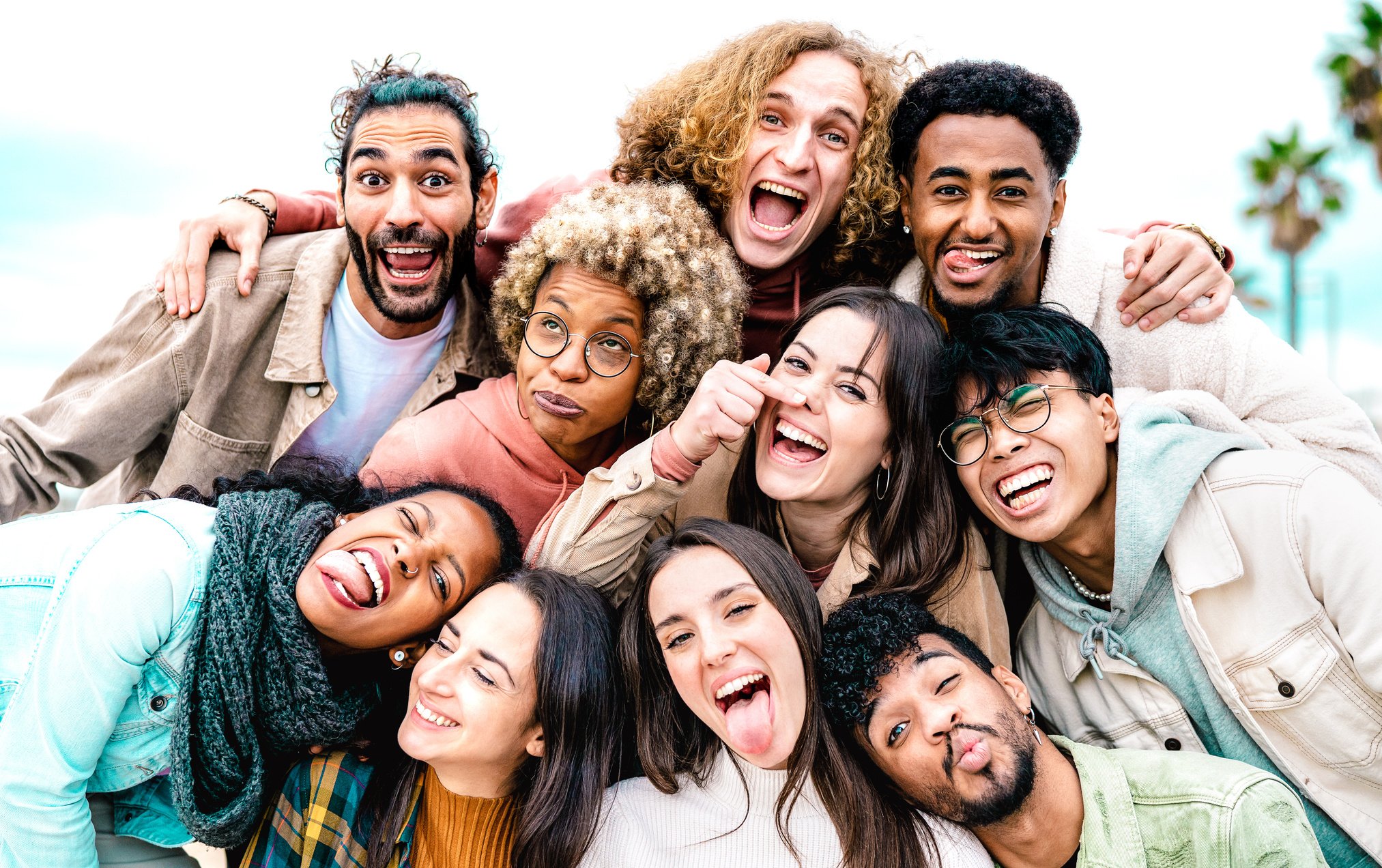 Multi cultural guys and girls taking best selfie outside on trav